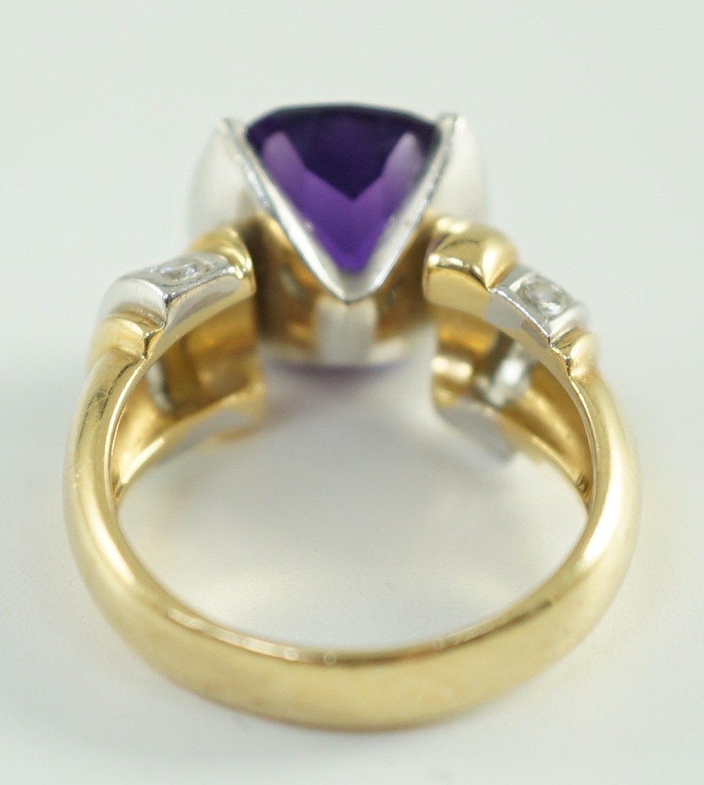 A modern 18ct gold and cushion cut amethyst set dress ring, with ten stone round cut diamond set shoulders